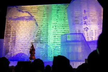 A singer performs against the illuminated backdrop of this enormous ice sculpture