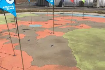 A fun map of each region in Fukushima, with the flags marking where solar energy production locations are in the area.
