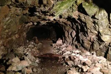 A tunnel closed to the public. Completely unlit and seemingly leading off into nothing.