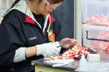 An employee at Sample Kobo makes plastic food replicas of shrimp tempura