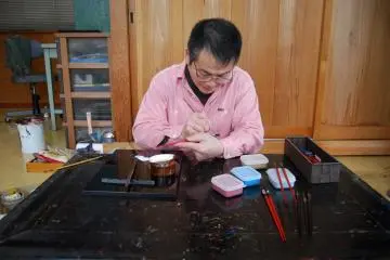 Watching Hayashi-san paint a tiny decorate symbol on lacquerware chopsticks is an honour.  