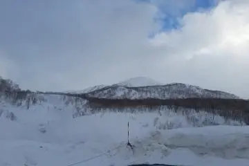 View over Oyunama thermal lake to the mountains beyond