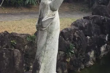 Chinese statue at the foot of the waterfalls -- a popular photo spot.