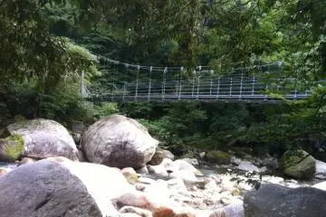 Walk across the rushing water and go for a hike in the mountains!