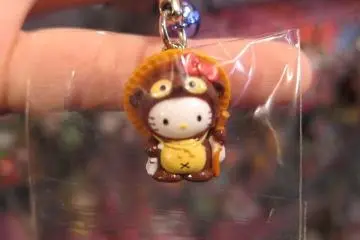 A cat or a racoon dog? A Hello Kitty dressed up as a Tanuki, which is an animal with shape-shifting abilities in Japanese folklore. Tanuki statues are commonly seen outside Japanese homes and shops.