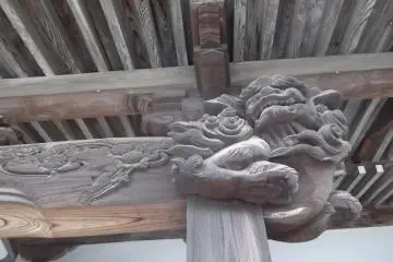 An airborne guardian lion, with detailed carving beside