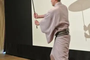 Fighting with his umbrella