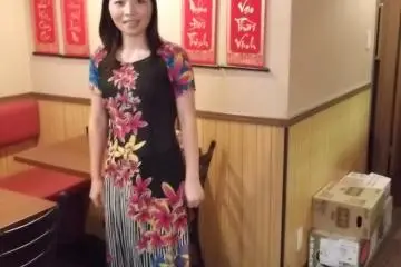 <p>The waitress in her colorful Vietnamese dress</p>