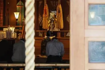 Praying inside the shrine.