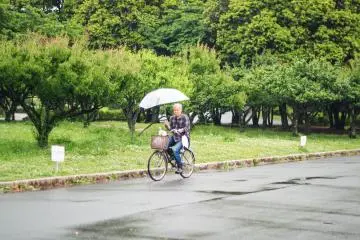 A man is cycling with his dog