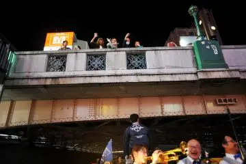 Enthusiastic on-lookers waving at the boat