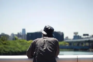 A man quietly enjoying the view from the bridge