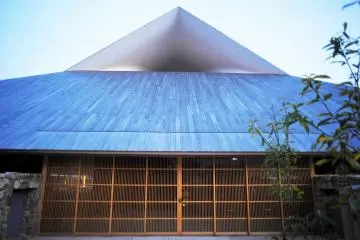 The hole in the gable captures the wind to help cool and ventilate the building
