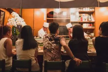 Customers at the sushi bar