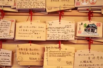 Visitors write wishes on a piece of wood and hang them along walls of the temple 