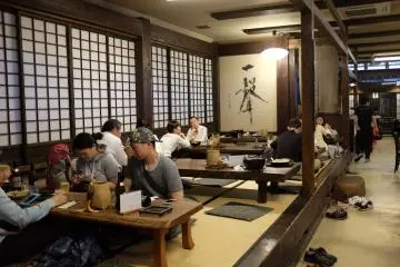 Seating is at traditional tatami-style booth and several wooden tables and chairs 