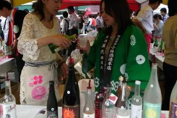 Having a little taste...you always pour for your friends first!