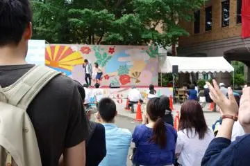 Students perform in pairs in something of a stand-up comedy session