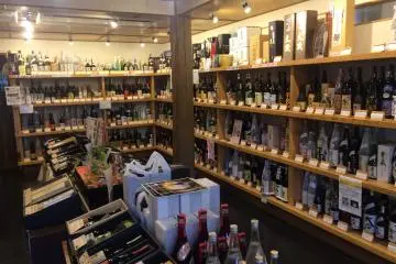 Shelves filled with a lot of sake bottles