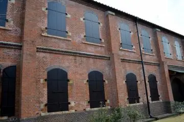 Dark red bricks and closed black windows. A quiet place.