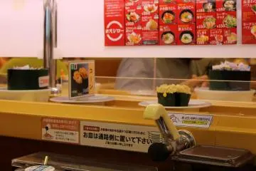 Sushi dishes are served via the rolling conveyor belt.