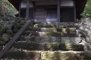 Climb the steps and you come to another hall in a forested clearing