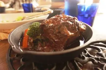 The beef meal served hot in a small black pan