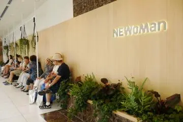 Shoppers rest to chat and admire the garden outside