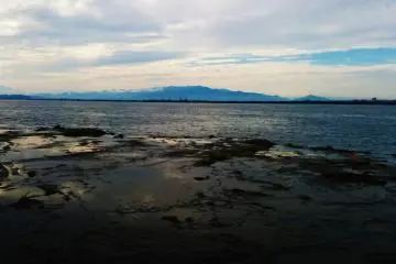 Rocky tide pools are visible along the beach.