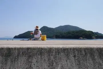 A fisherman trying his luck in the Tomo waters