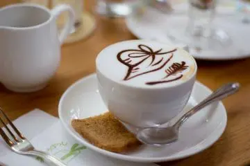 Kopinya disajikan dengan latte art ala Straw Hat Cafe