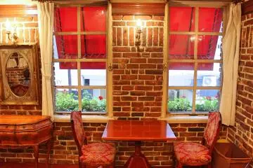 Upstairs there is a cozy room with a carpet and big windows