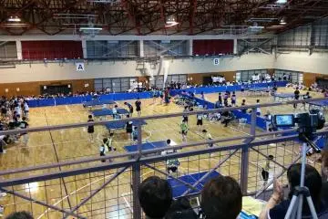 Table tennis matches in the springtime, seen from the parent-filled balcony.