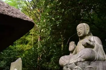 Jizo statue sits on the grounds of Shomyoji Temple