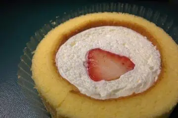 Premium Roll Cake with a Cut Strawberry on Top