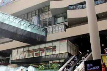 At the bottom of the escalators leading down from Nankai Namba Station.