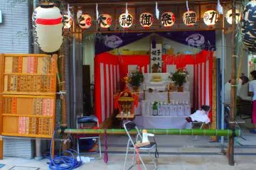 After a parade around the district, a portable shrine takes a rest