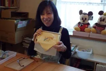 Mani-San showing the progress of her project
