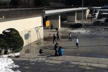 <p>Young people playing three points game of basketball downstairs at the Plaza.</p>

