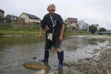 With a great smile, the fisherman completed his morning capture