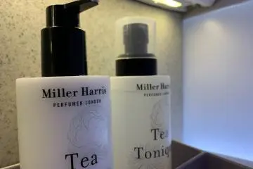 A full array of toiletries in Business Class bathroom, including tea mist