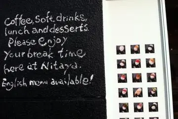 Welcoming Sign in English on Outside wall