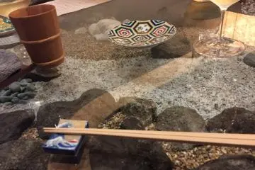 The glass countertop with a zen-like display beneath