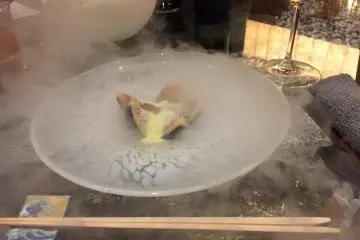Black fig from Sado Island with frozen olive oil being poured over it