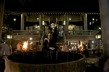 A huge barrel for offerings stands in the shrine's forecourt.
