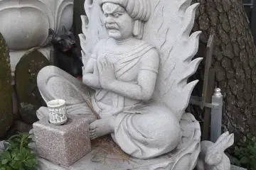 A seated Buddhist deity with animal companions