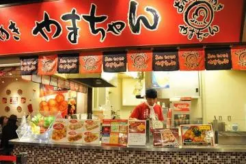 The kitchen areas of each restaurant are right next to customer walkways. The wonderful smells influence you to buy more and more. This is a view of the Yamachan restaurant.