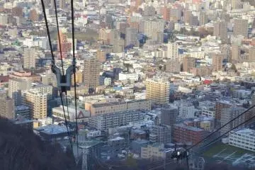 The descending cable car prepares to pass the ascending car. Passengers are asked to wave as they pass.