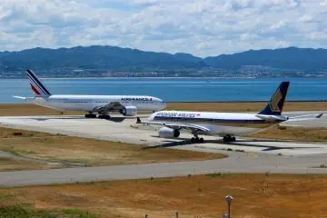 2 planes on the runway at Kansai Airport. Your journey in Japan might begin here.