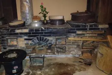 The traditional kitchen. The kama, large iron pot for making rice, is dominant.